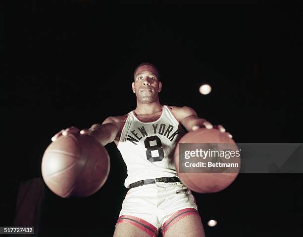 Nat Sweetwater Clifton, of the New York Knickerbockers, holding a basketball in each hand.