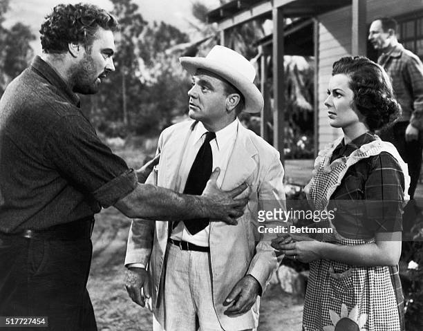 Picture shows actors, James Cagney and Barbara Hale, in a scene from the movie, "A Lion in the Strets". Cagney is pictured in a white suit and hat,...