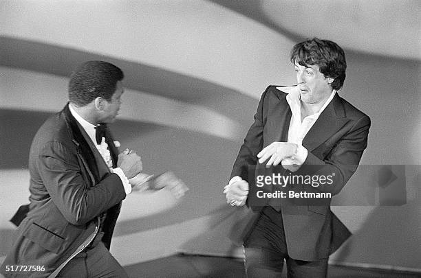 Actor Sylvester Stallone , and world heavyweight champion Muhammad Ali playfully square off on stage as Ali made a surprise appearance at the 49th...