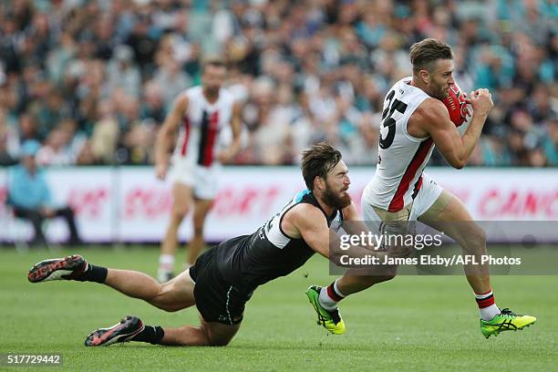 Charlie Dixon of the Power tackles Sam Fisher of the Saints during the 2016 AFL Round 01 match between Port Adelaide Power and the St Kilda Saints at...