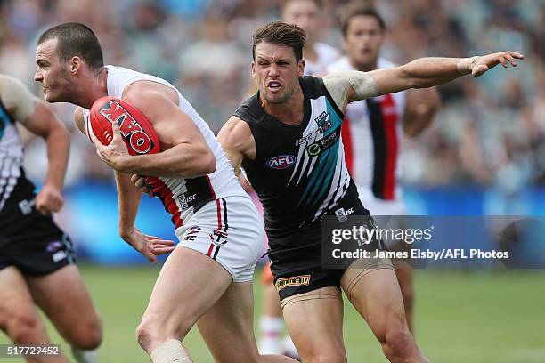 Dylan Roberton of the Saints is tackled by Travis Boak of the Power during the 2016 AFL Round 01 match between Port Adelaide Power and the St Kilda...