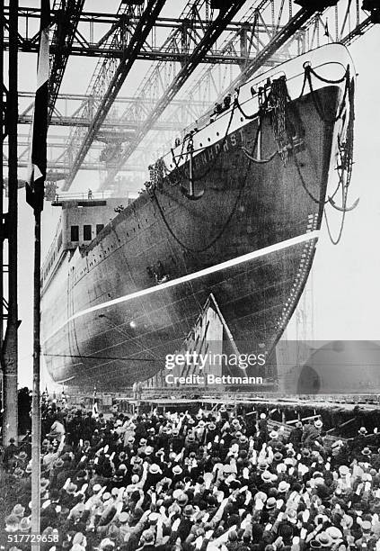 German citizens are shown giving the Nazi salute as the new north German Lloyd line steamship Scharnhorst leaves the slipways at Bremen recently...