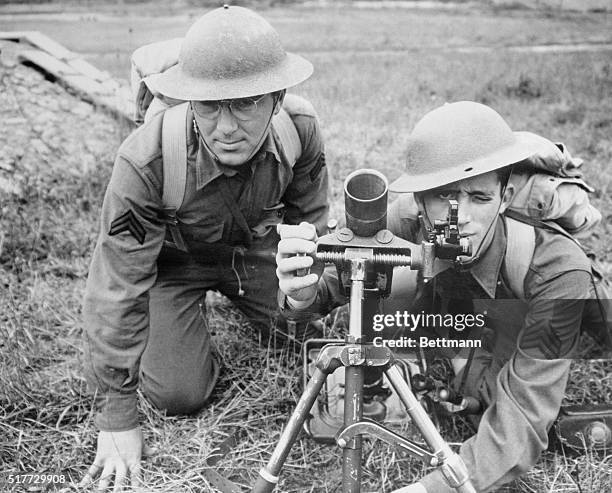 Left to right are Corp. Tricarico and Sgt. William of the 112th Infantry, 28th Division, as they grimly go about their training on a trench mortar.