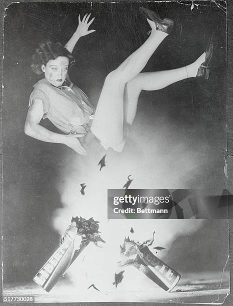 American actress Joan Crawford soars through the air as a firecracker explodes below her in the making of a Fourth of July picture.