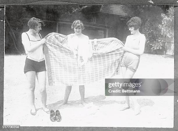 Evidently they have no beach censors at German seashore resorts for these three young women had to dress on the beach for their plunge in the third...