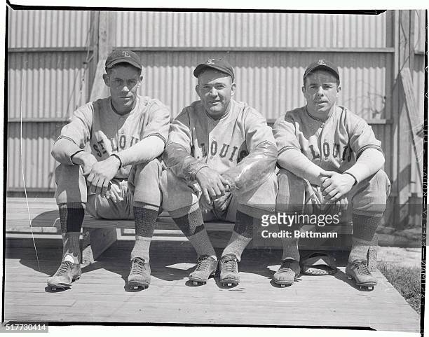 Rogers Hornsby, , Manager of the St. Louis Browns, is shown here with Leroy Mahaffey, , the right-handed pitcher, and Thomas Carey, , second baseman...