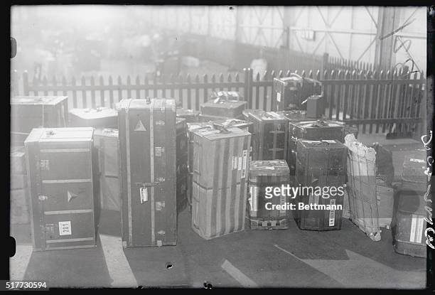 Photo shows a few of the trunks belonging to Queen Marie and her entourage being placed at pier awaiting arrival of transportation vehicles to take...