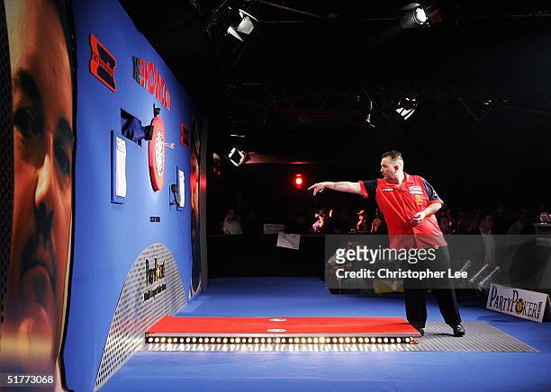 Phil Taylor practices as he waits for the return of Andy Fordham during the Showdown match at The Circus Tavern November 21, 2004 in Purfleet,...