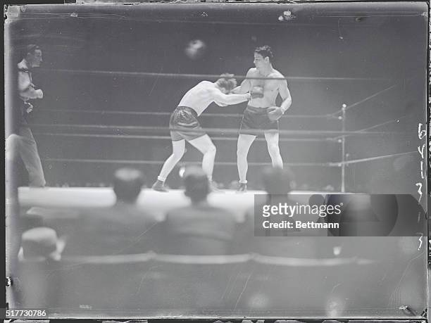 Stanley Poreda tries to land with an uppercut as Ernie Schaaf ducks low in the fourth round of their bout at Madison Square Garden. Schaaf was...
