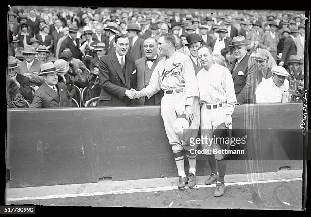 Rogers Hornsby is shown being congratulated by Mayor Jim Walker of New York upon the St. Louis victory in the second game. Jake Ruppert, Yanks owner,...