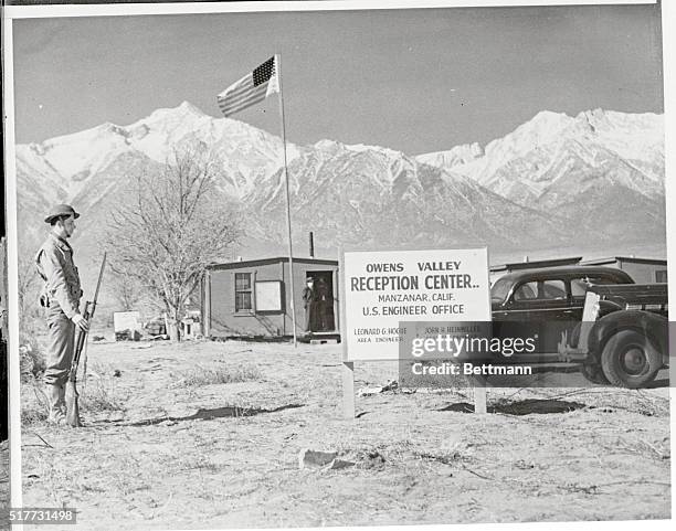 Sentry Guards Alien Center. Manzanar, California: Adding a military air, a sentry paces the boundary line of the new Owens Valley Reception Center at...