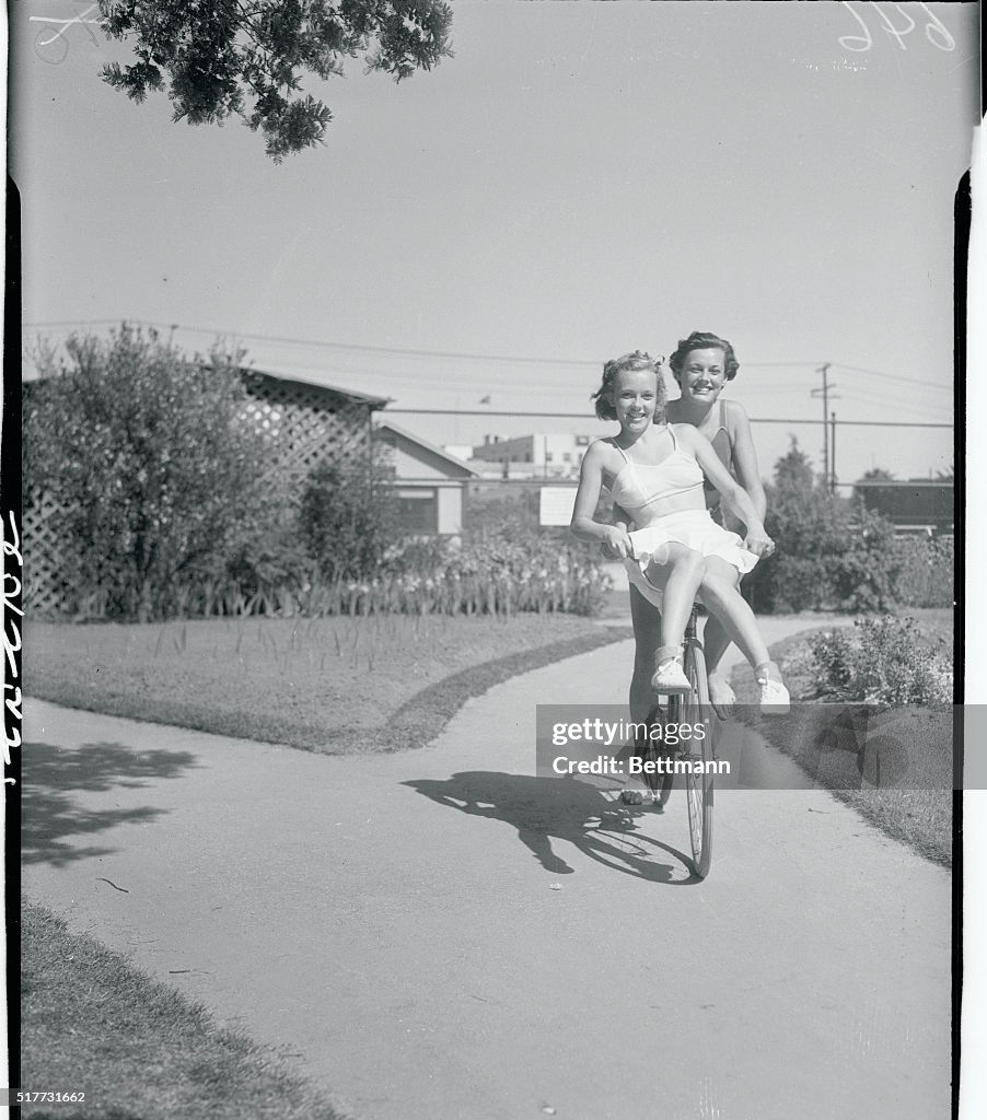Eleanor Holm and Dorothy Lee Riding Bicycle
