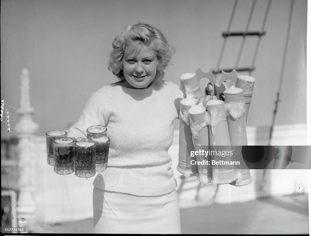 Barmaid Carrying Glasses of Beer