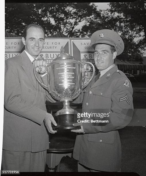 Sam Snead and Corporal Jim Turnesa, Fort Dix, New Jersey, hold the trophy they will battle for today in the finals of the PGA championship. Corporal...