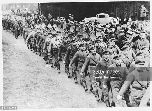Law students who are going to have their own military camp here, are seen with spades, marching to the site to celebrate the turning of the first...