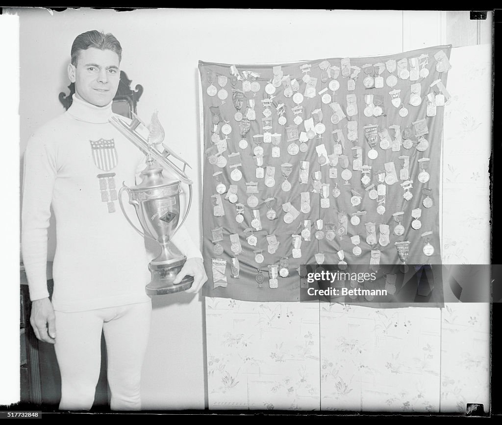 Charles Jewtraw Posing with His Medals and Trophy