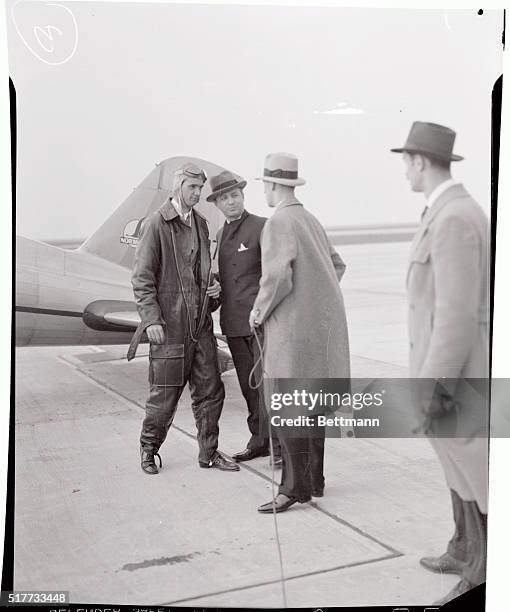 Howard Hughes, and Albert Lodwick, aviation official, , , pictured shortly after Hughes had arrived in his low-wing Northrup all-metal monoplane at...