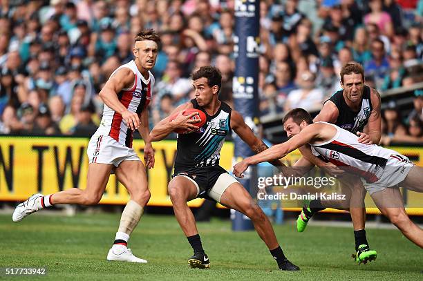 Brendon Ah Chee of the Power attempts to break a tackle during the round one AFL match between the Port Adelaide Power and the St Kilda Saints at...