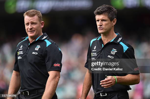 Assistant coaches of the Power Michael Voss and Nathan Bassett walk and onto the field during the round one AFL match between the Port Adelaide Power...