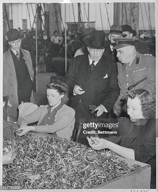 Prime Minister Inspects Work in Arsenal. Quebec, Canada: The Right Honorable W.L. Mackenzie King, prime minister of Canada, watches women munitions...