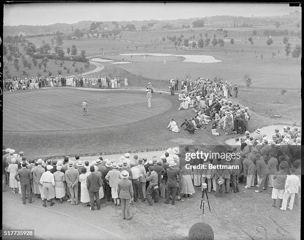 General view of Gene Sarazen sinking birdie two on 9th hole. Sarazen played a 38 on first nine.