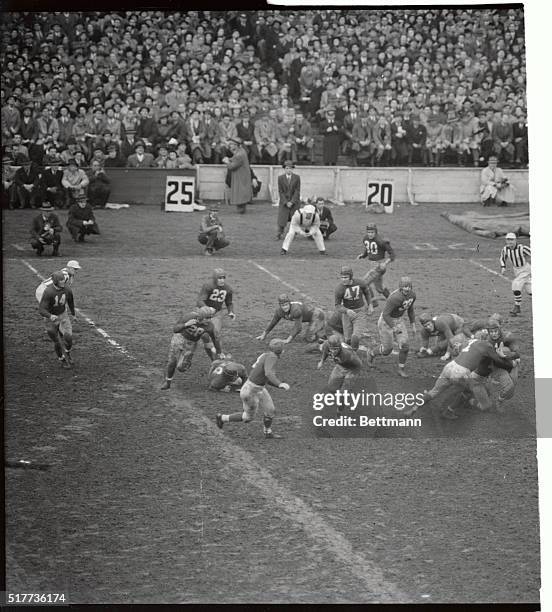 Andy Farkas of the Washington Redskins is seen carrying the ball for a sort gain around left end to be tackled by Mel Hein of the Giants in a game at...