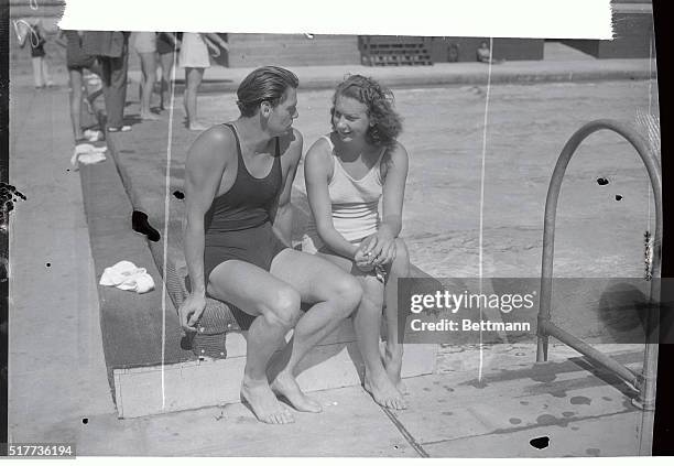 Helene Madison conceded to be the World's fastest woman swimmer and Johnny Weismuller, holder of many world's speed records, pictured chatting hers...