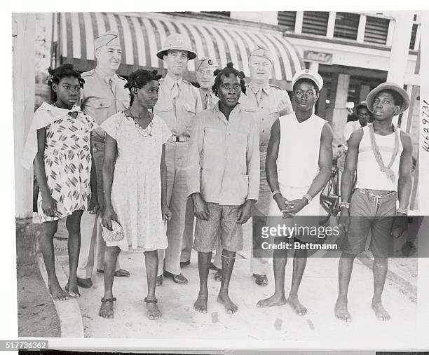 American Army officers are shown here with a group of bush Blacks in Surinam, South America. These Bush Natives are descendants of slaves who lived...