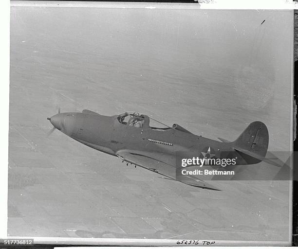 Flying high over the countryside, this sleek, sharp nosed army P-39, also known as the Aircobra, is of the type used by US Army Air Force pilots...