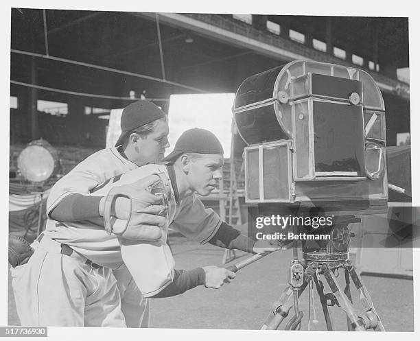 Left to right: Larry French, Pittsburgh Pirate south paw, and Babe Herman, demon slugger who joins the Chicago Cubs this Spring, as they decide that...