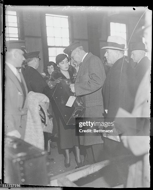 Getty Gow Returns. New York: Betty Gow, who was nurse for the murdered Lindbergh baby has her baggage checked as she returns to America on the...