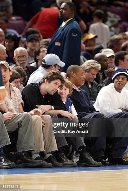 Director Bart Freundlich, son Caleb, Rapper Jay-Z and friend Tyran "Ty Ty" Smith sit courtside at the New York Knicks versus Cleveland Cavaliers NBA...