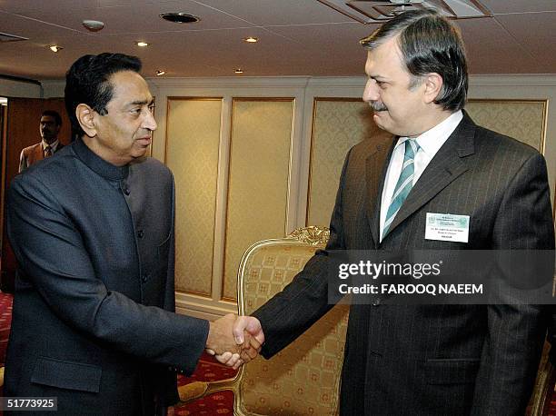 Pakistani Commerce Minister Humayun Akhtar shakes hands with his Indian counterpart Kamal Nath prior to a South Asian Association for Regional...