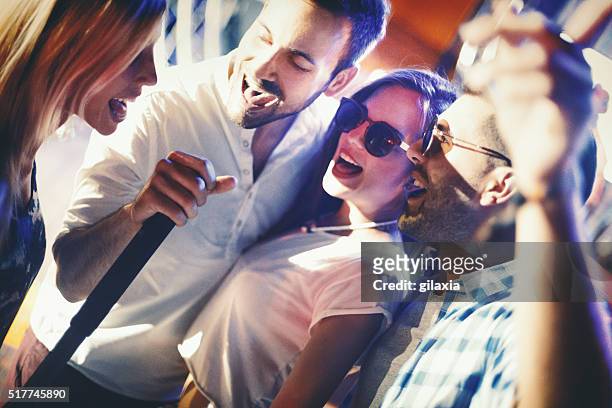 group of people singing karaoke. - male singer stock pictures, royalty-free photos & images