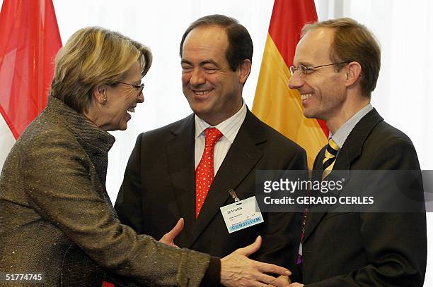 French Defence Minister Michele Alliot-Marie greets her Spanish counterpart Jose Bono and Luxembourg counterpart Luc Frieden 22 November 2004 before...