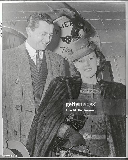 Robert Young, screen star, and Mrs. Young arrive at Laguardia Airport, December 1st, after a flight from the coast . They will fly to Boston to...