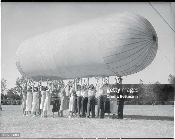 North Hollywood, California: Dirigible Model. A Pretty Ground Crew Has This Novel Dirigible model at North Hollywood. On the 35-foot model ship,...