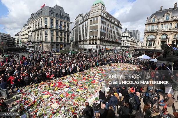 People gather in Place de la Bourse square at a makeshift memorial to pay tribute to the victims of Brussels terror attacks, in Brussels, on March...