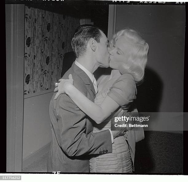 Screen actress Mamie Van Doren and orchestra leader Ray Anthony kiss after their wedding ceremony in the bridal suite of the Hotel Commodore Perry in...