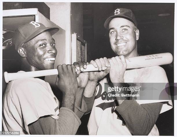 Mighty with the Mallet. New York, New York: Dodger heroes Sandy Amoros and Duke Snider "wield the willow" in the dressing room after wielding against...