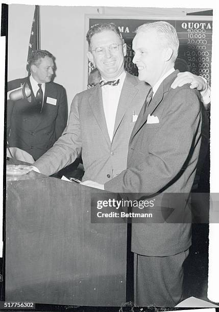 Resigning Democratic National Chairman Stephen A. Mitchell warmly congratulates his successor, Paul A. Butler, of South Bend, Indiana, after Butler...