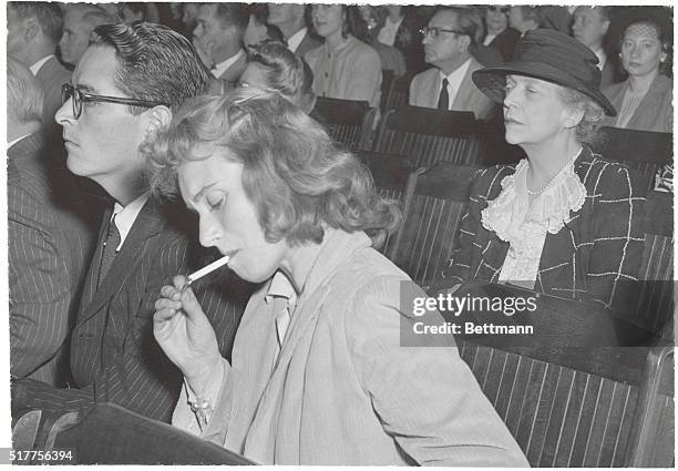 Washington, DC: Listening To Hearings On Hollywood "Red" Probe. Ring Lardner, Jr., and his wife, actress Frances Cheney, are pictured listening to...