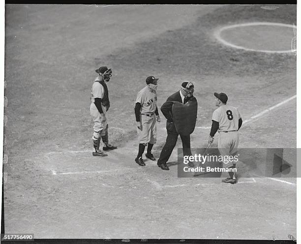 Unhappy with Kansas City Athletics pitcher Arnold Portocarro's frequent use of the resin bag on the mound, New York Yankee catcher Yogi Berra, #8,...