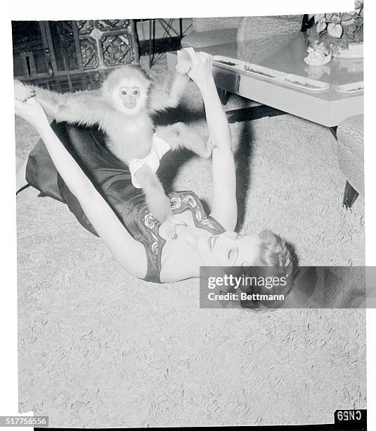 Debra just loves to play with her 16 month old pet gibbon, a gift from a friend. The tiny simian, who wears diapers, is one of the many pets in the...