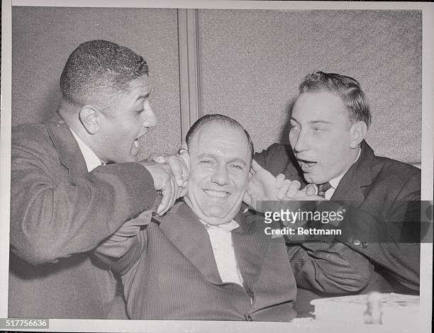 Brooklyn, New York: Buzzie Bavasi, Dodgers vice president and general manager, covers up in a bit of horse play during a talk with pitchers Don...