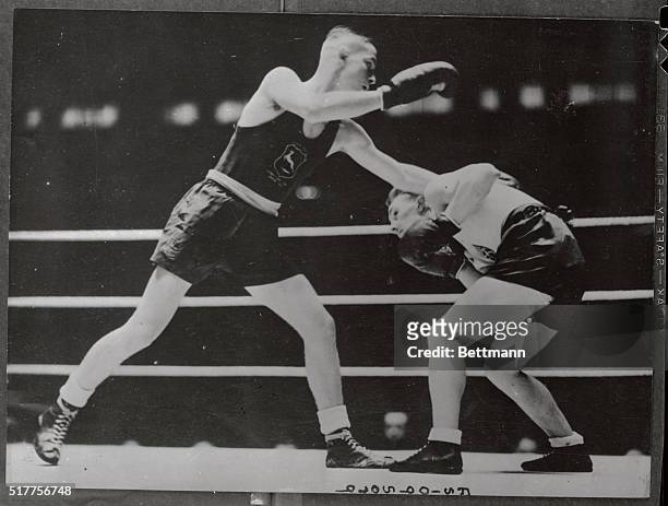 Olympic boxing finals at Wembley is shown here with T. Csik, of Hungary, in white socks, and G. E. Zuddas of Italy, during their bout in the...