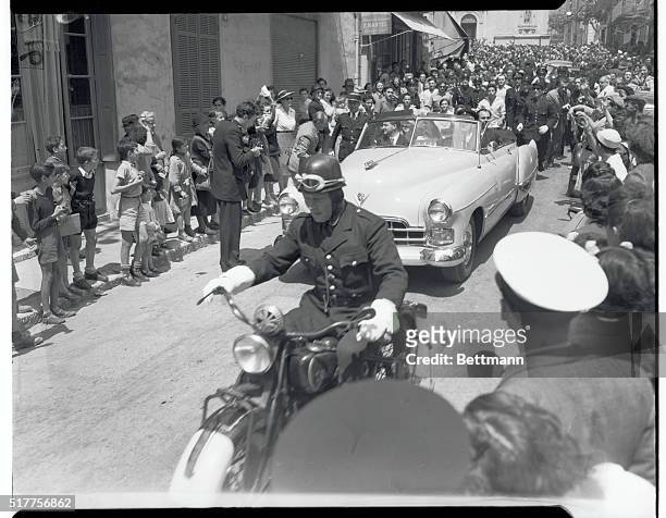 Crowds Cheer Rita and Aly after Ceremony. Vallauris, France: Preceeded by motorcyle police escort, screen actress Rita Hayworth and her new husband,...