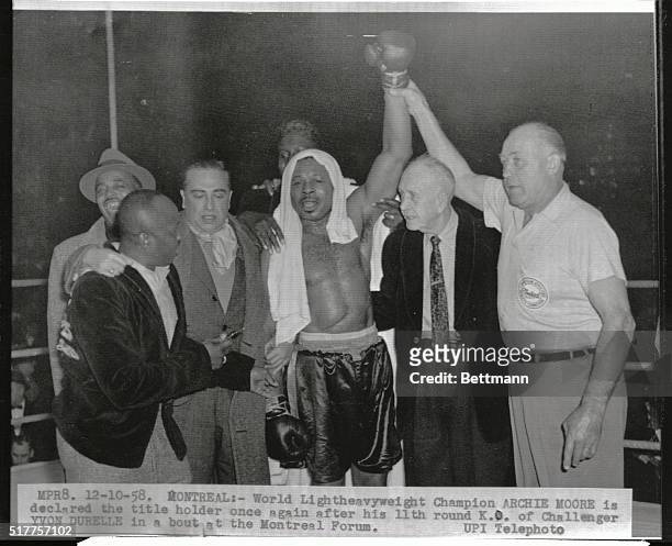 The World Light Heavyweight Champion Archie Moore is declared the title-holder once again after his 11th round knock-out of challenger Yvon Durelle...