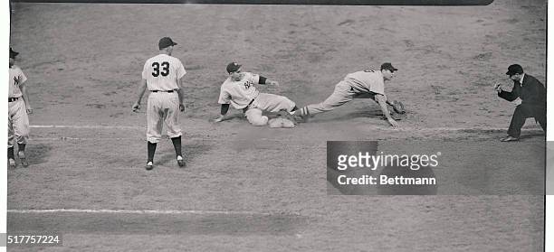 Yogi Berra of the New York Yankees is tagged out at first base in the Stadium tonight as he tried to get back to the sack. Gene Woodling's liner to...