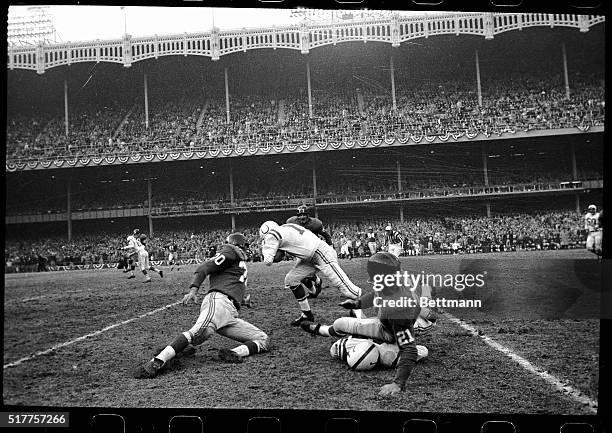 With L.G. DuPre leading the way, Johnny Unitas of Baltimore, breaks through the Giants' line to ramble 16 yards in the second quarter. Shortly after...